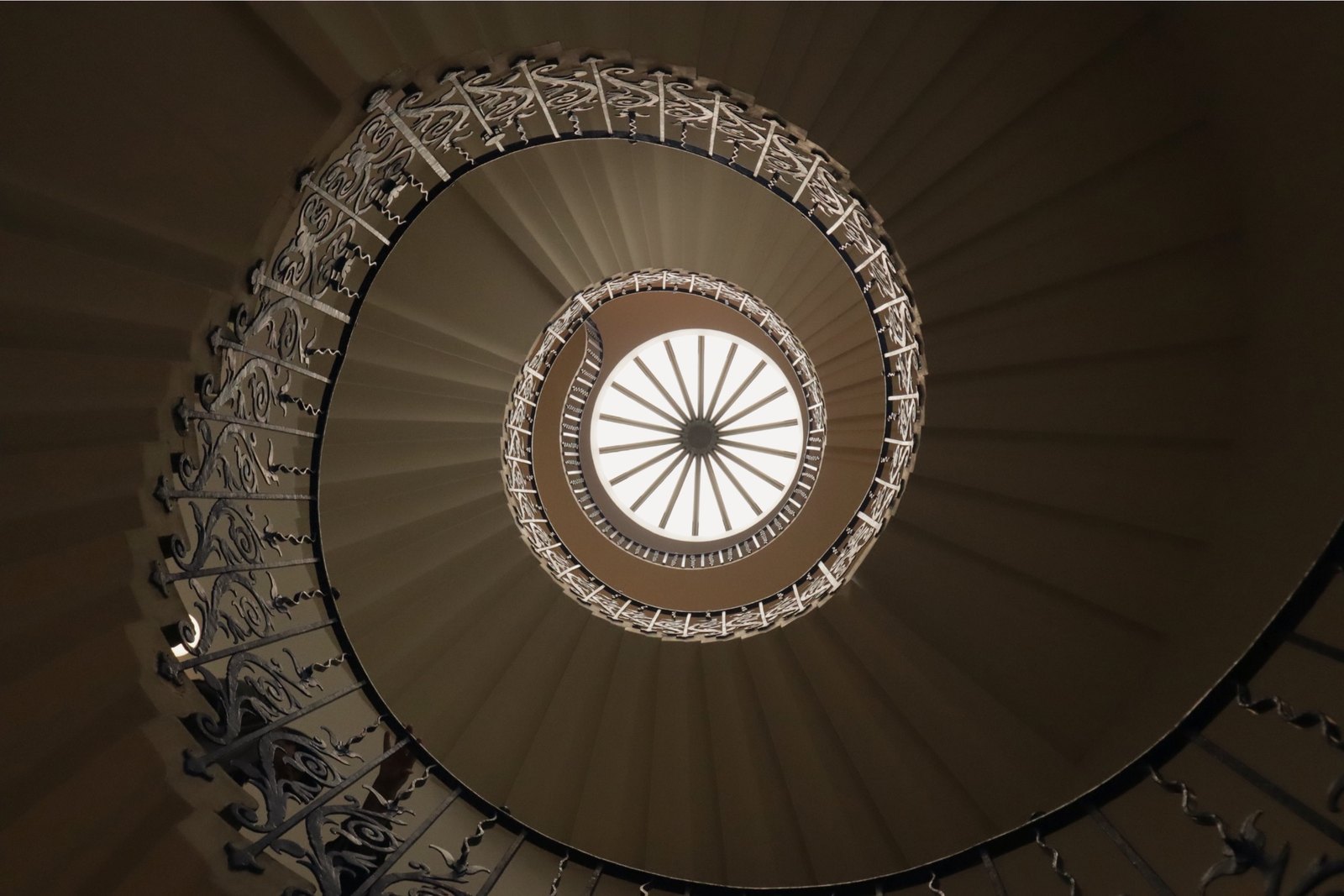 Looking up at a tulip spiral staircase at the Queen's House in Greenwich, London